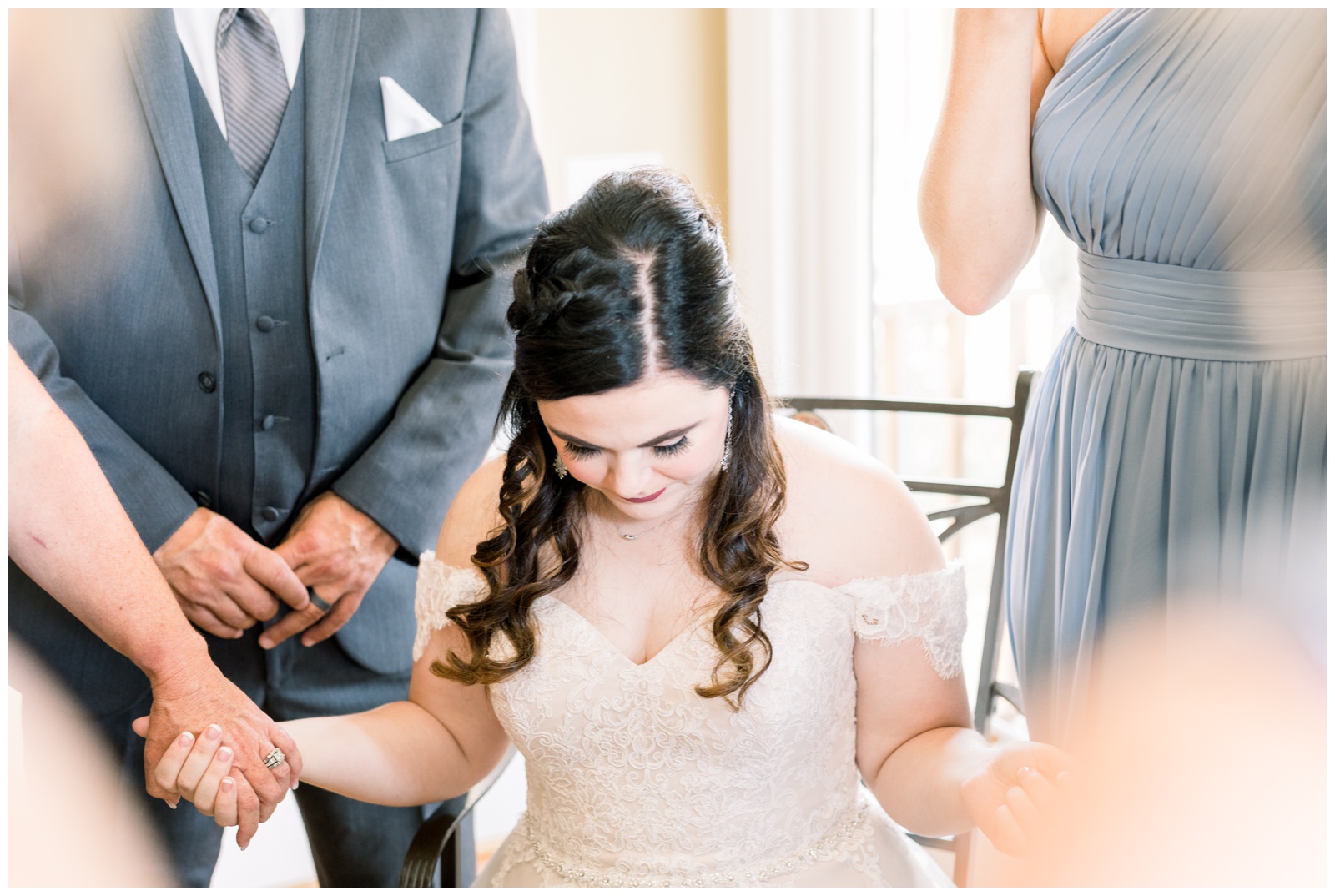 southern bride praying with family and bridesmaids, atlanta ga wedding photographer