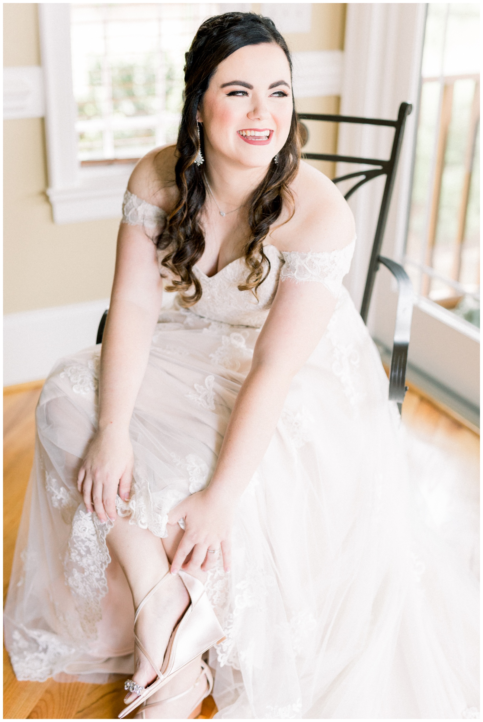 bride smiling while putting on shoes, Atlanta GA wedding photographer